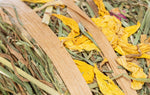Close up of the Trixie Hay Roll with Blossoms showing yellow flower petals and cellulose tape wrap